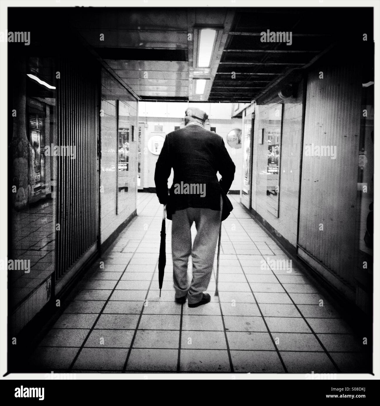 Senior citizen in underground station ,photographed from behind - Smartphone Captured Stock Image
