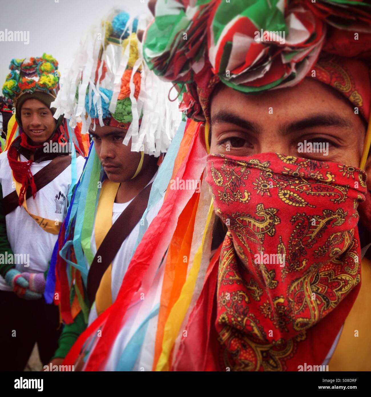 Dancers from Mancuerna, Tepeyahualco, Puebla perform the Danza de los Negritos during the pilgrimage to the Basilica of Our Lady of Guadalupe, Tepeyac Hill, Mexico City, Mexico - Smartphone Captured Stock Image