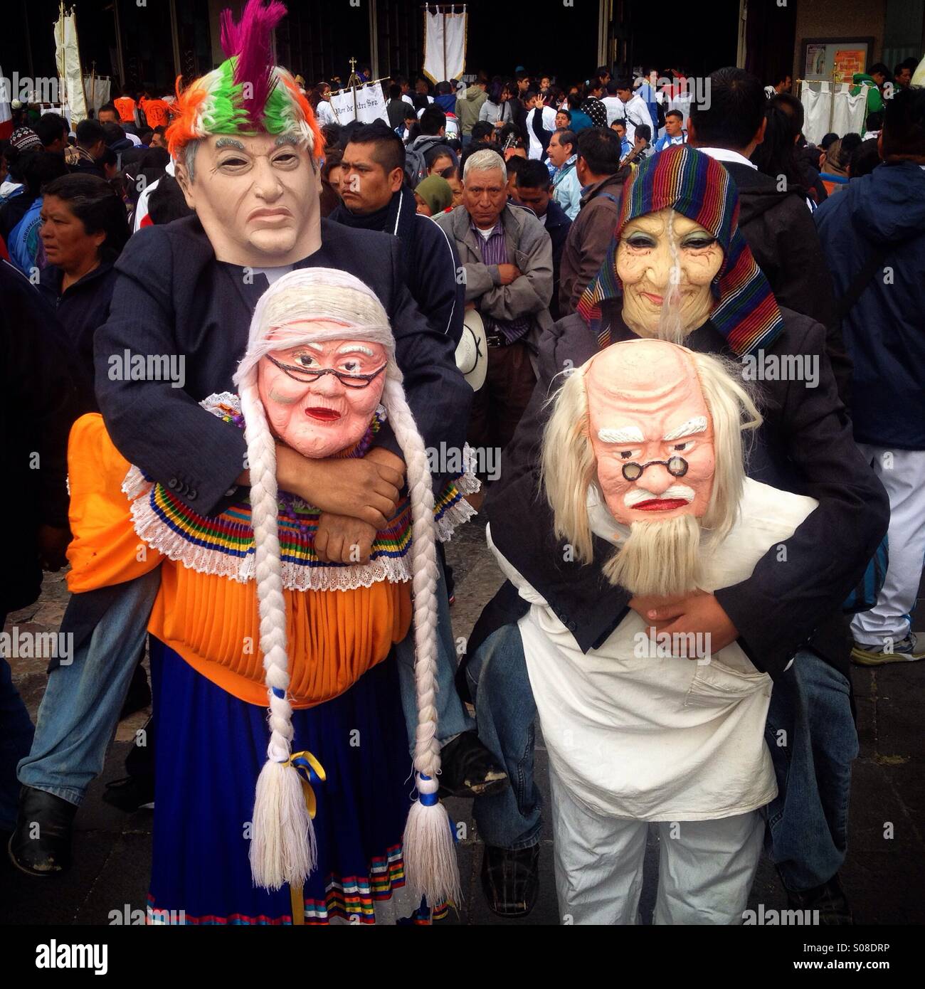 A father and his son from Tlapa, Guerrero dressed to perform the Danza de los Chones during the pilgrimage to the Basilica of Our Lady of Guadalupe, Tepeyac Hill, Mexico City, Mexico - Smartphone Captured Stock Image