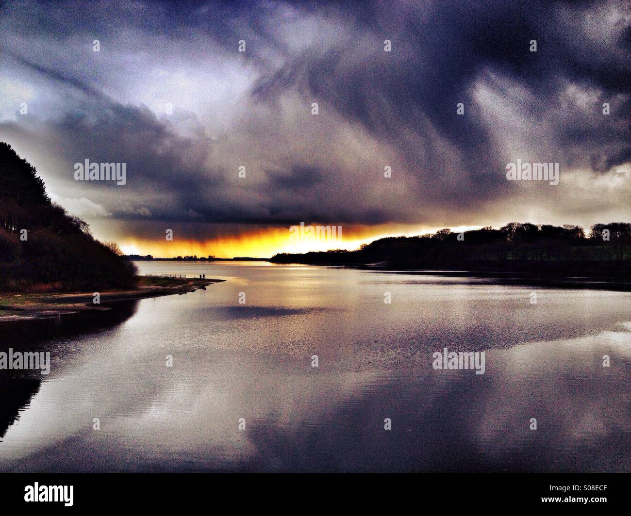 Evening light and approaching storm over Rivington reservoir near Chorley Stock Photo