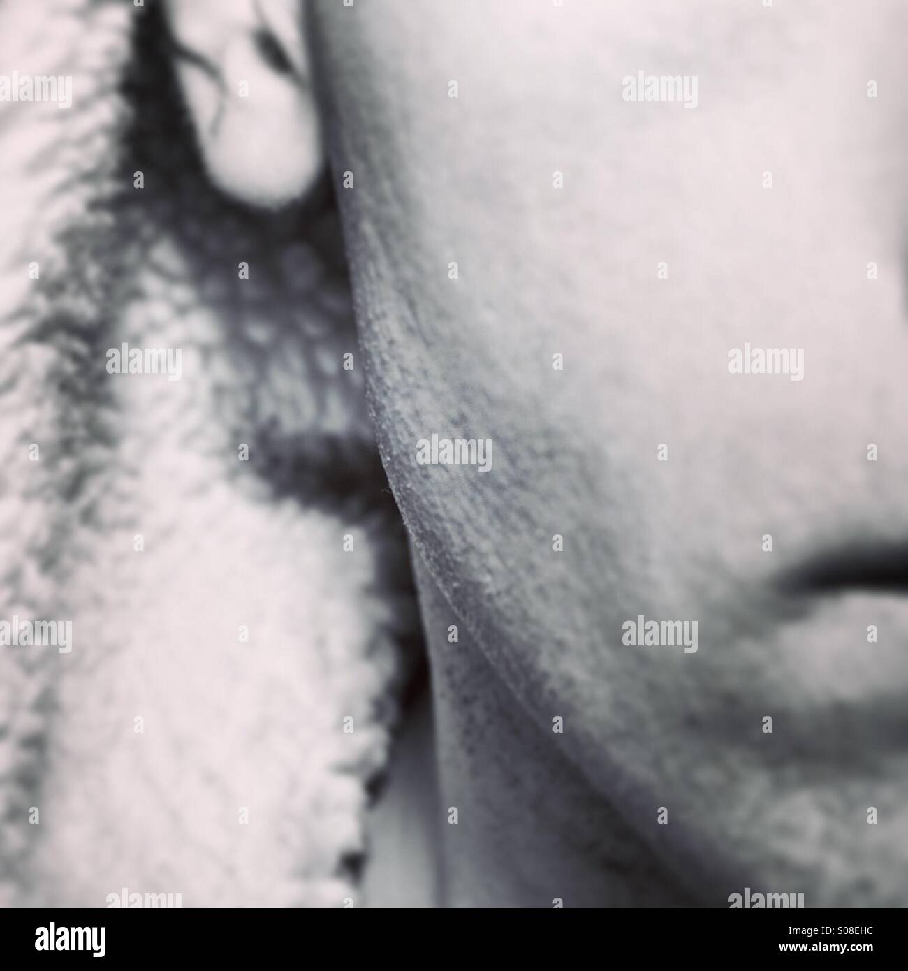 Close up on jaw bone of hooded male - Smartphone Captured Stock Image