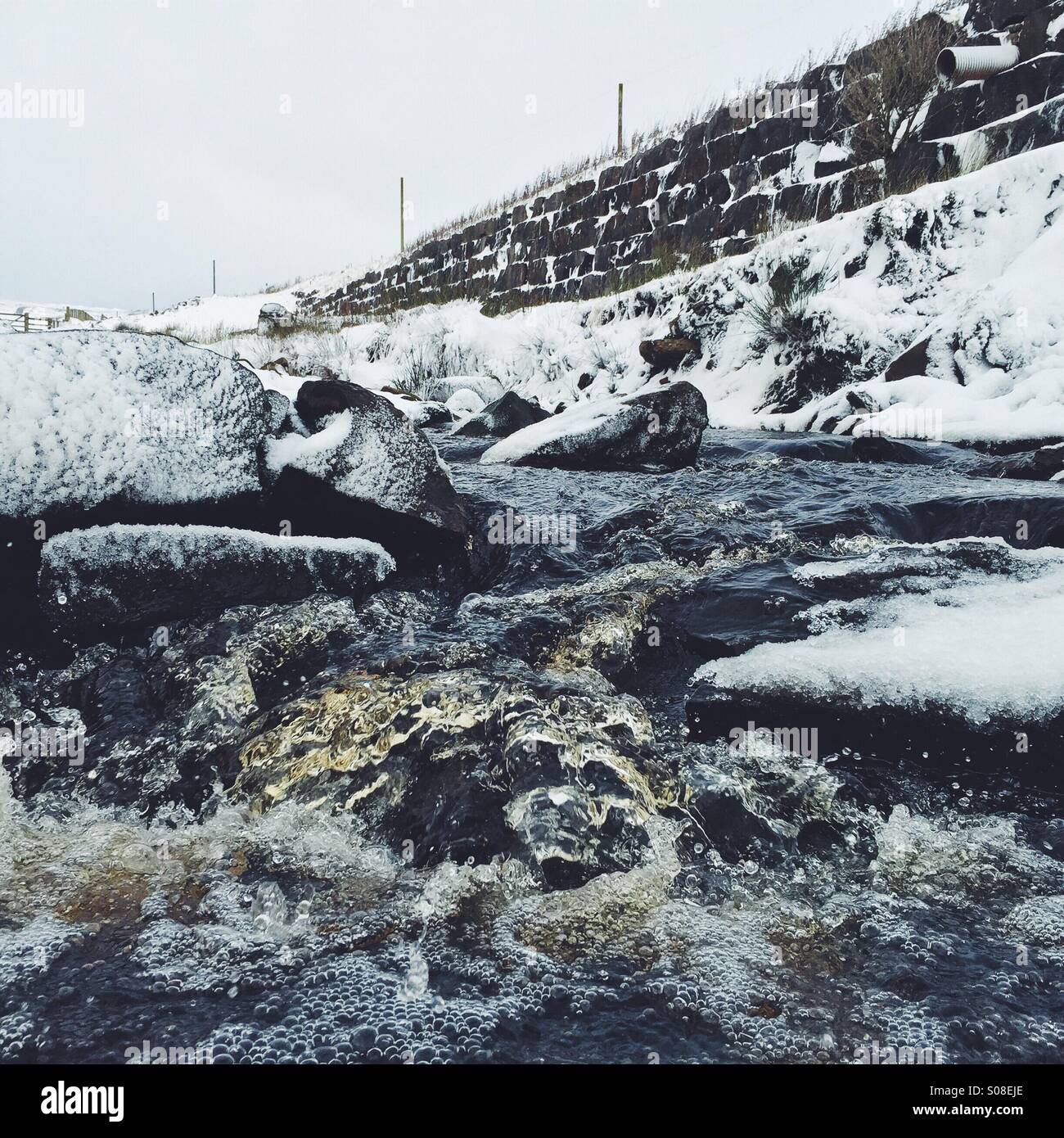 A little stream in the middle of snowy Middleton in Teesdale, U.K. - Smartphone Captured Stock Image