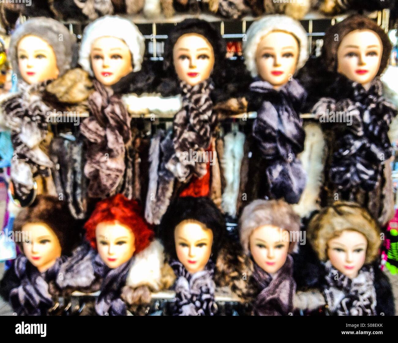 Female Manikins displaying faux fur hats and scarves on a market stall, England, UK - Smartphone Captured Stock Image