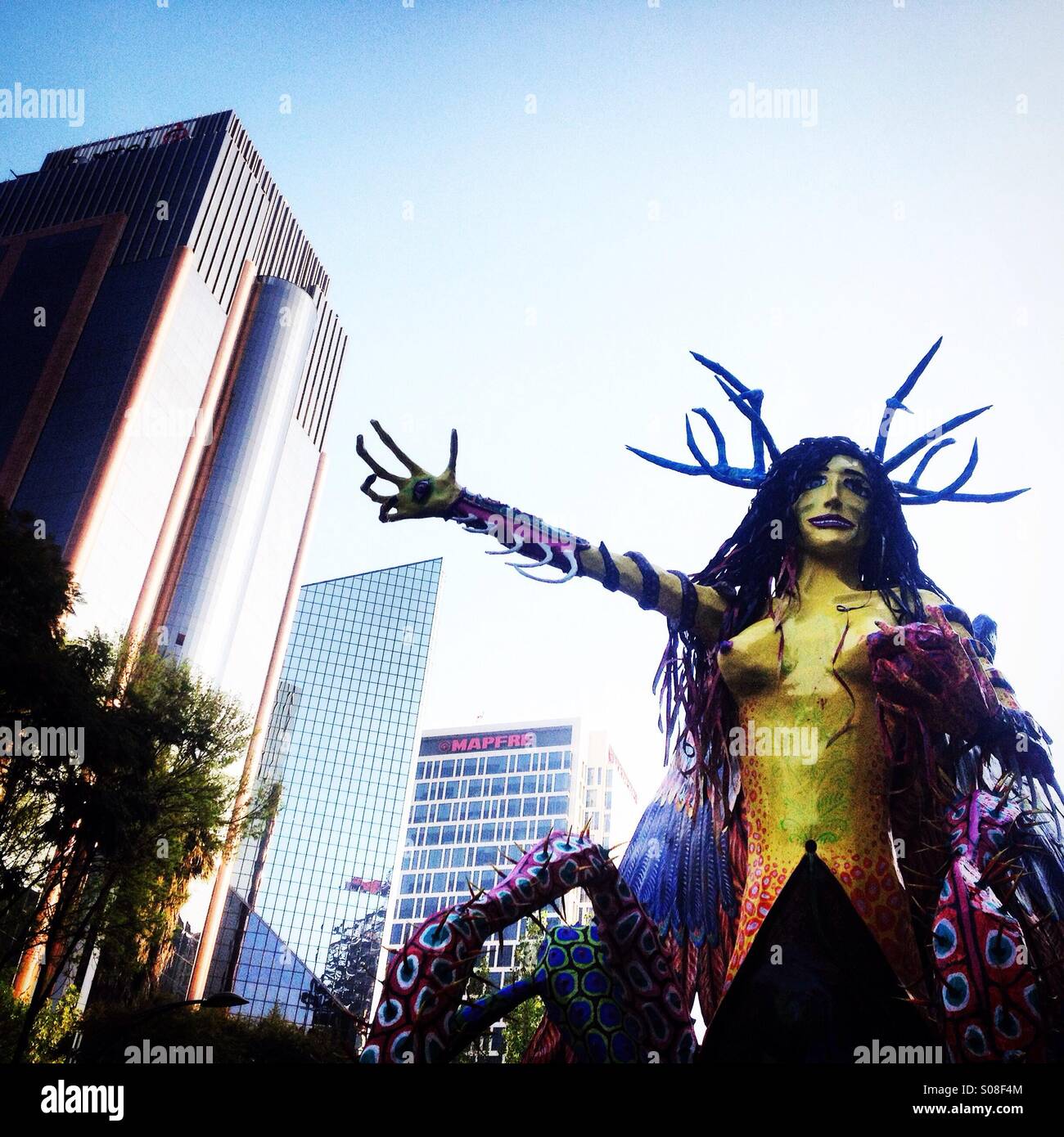 Paper mache sculpture of a fantastic monster at the Parade of Alebrijes Monumentales in Reforma Avenue, Mexico City, Mexico. Art work called Ladrona de Sueños by artist Carlos Arredondo Martinez - Smartphone Captured Stock Image