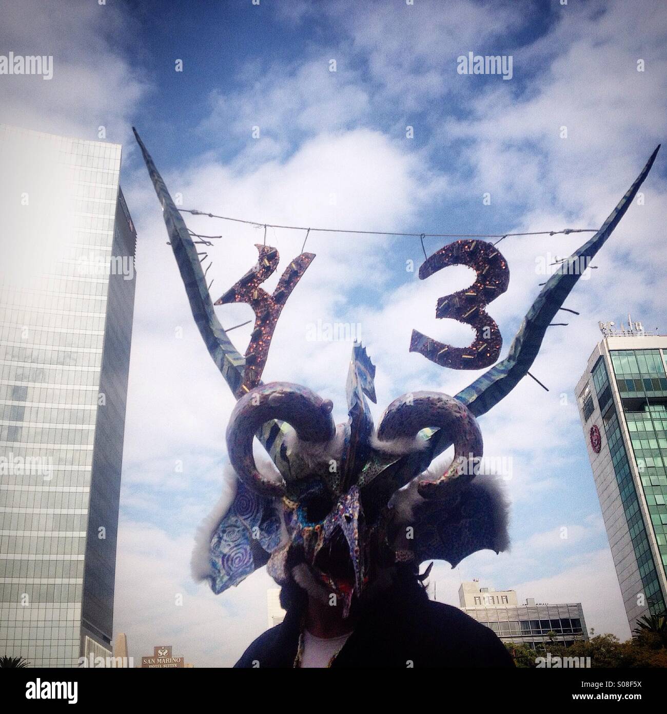 A man wears a mask and horns with the number 43 demanding justice for the dissapearing of the 43 students of Ayotzinapa, that dissapeared in Iguala, Guerrero, Mexico - Smartphone Captured Stock Image
