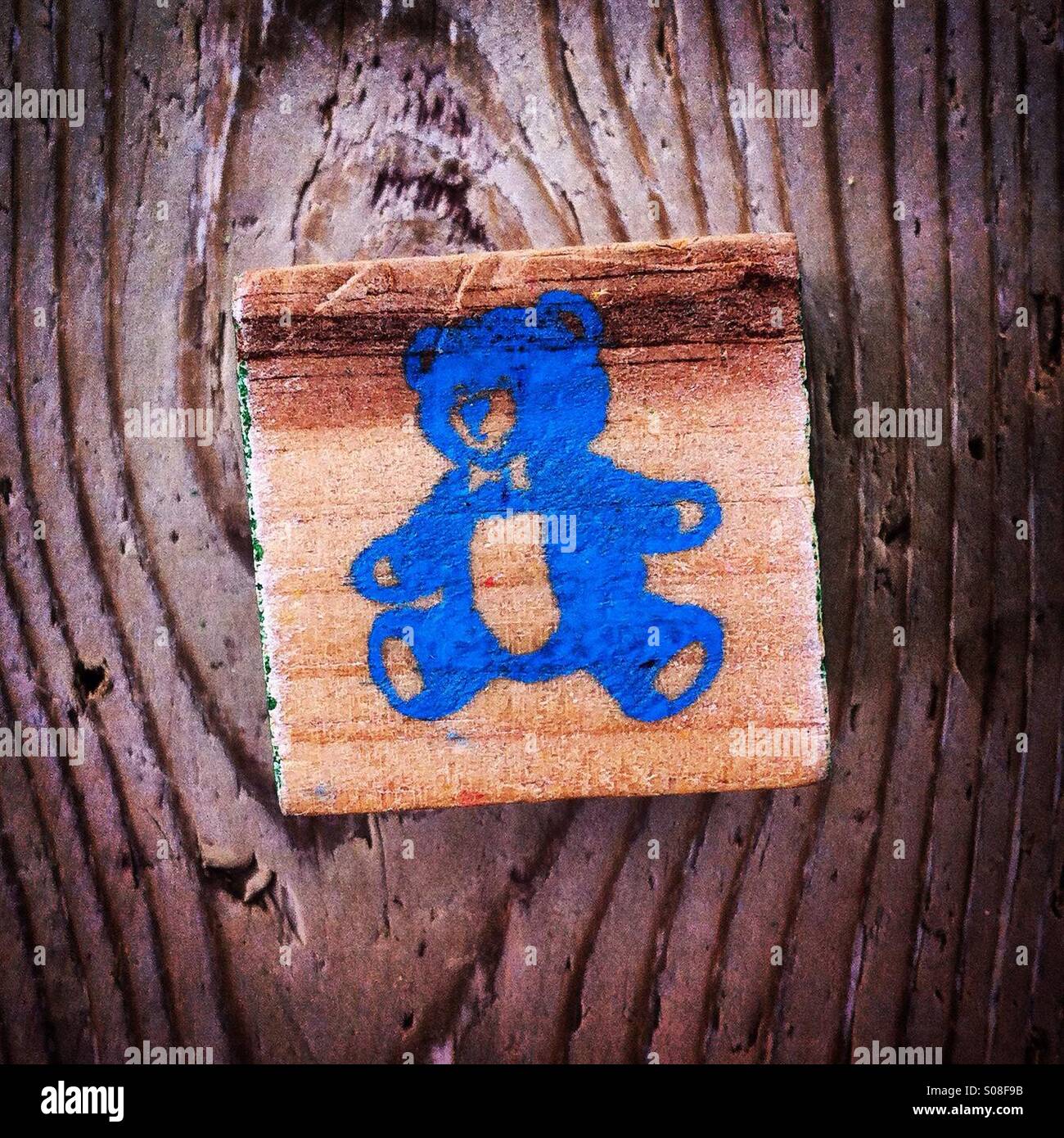 Blue teddy bear painted on a wood block - Smartphone Captured Stock Image
