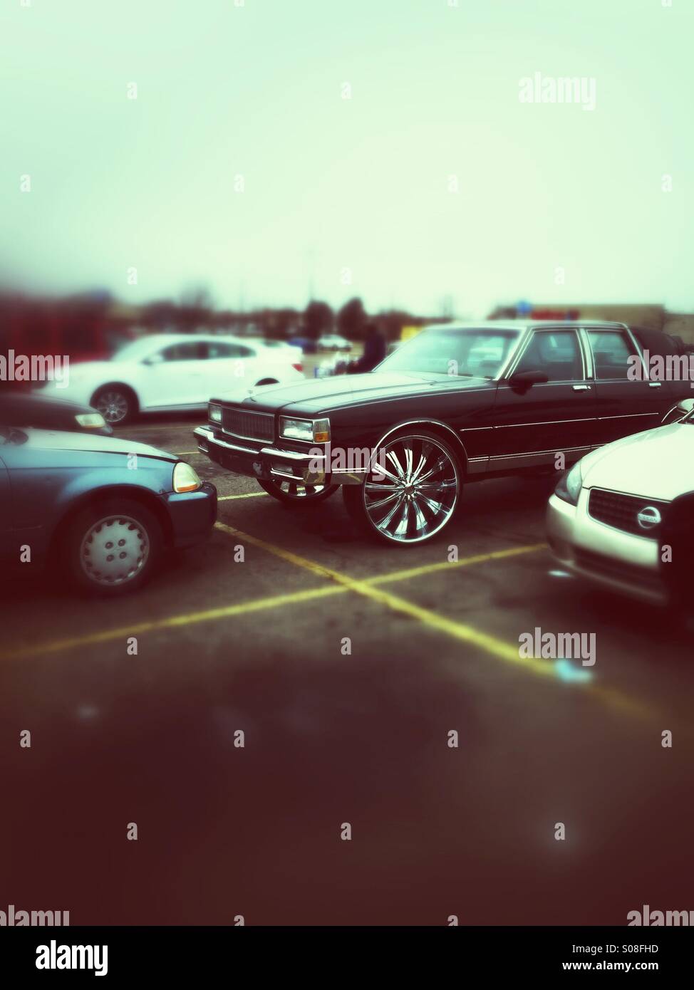 An older sedan with giant wheels - Smartphone Captured Stock Image