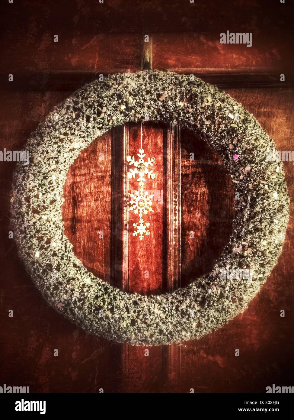 A silver Christmas wreath having on wood paneling Stock Photo