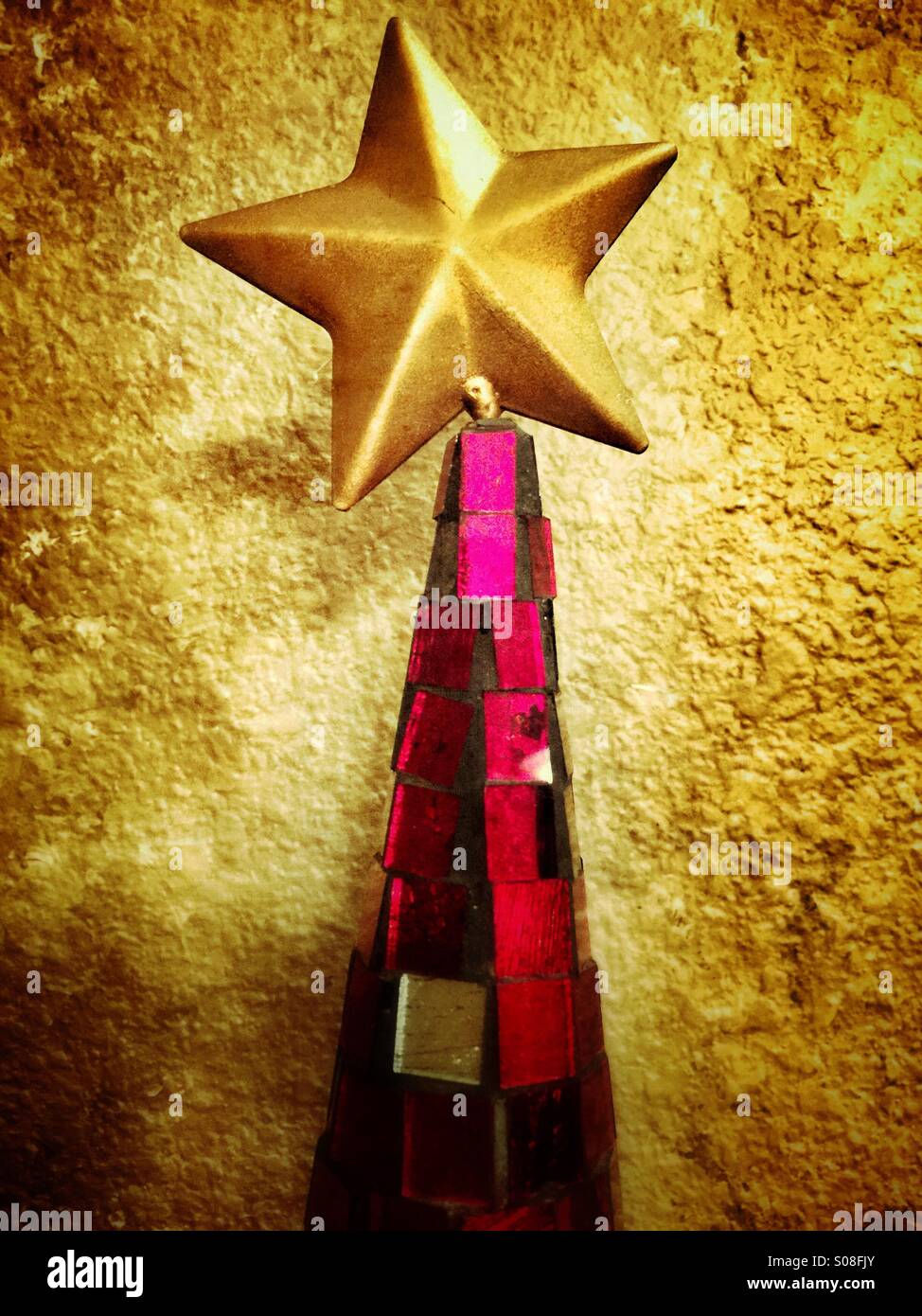 A gold star sitting on top of a red mirrored cone - Smartphone Captured Stock Image