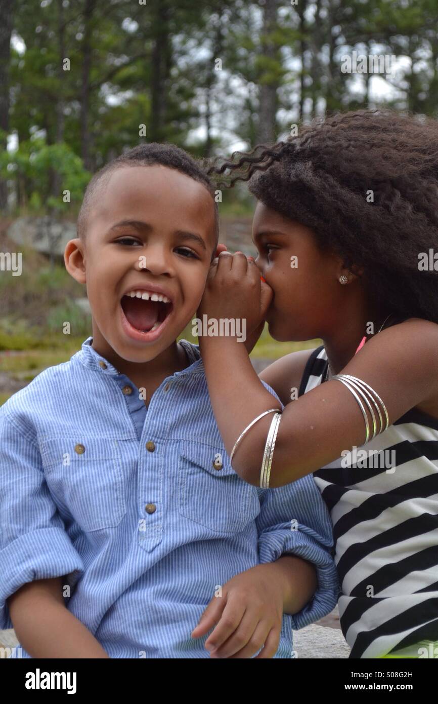 Boy and girl telling jokes Stock Photo
