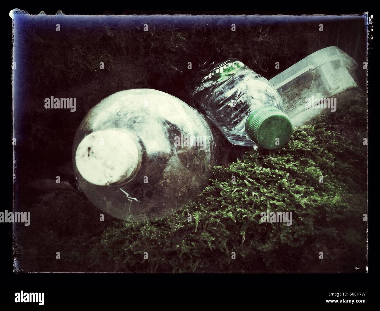 Discarded plastic bottles in the countryside Stock Photo