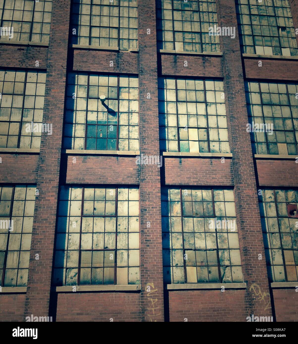 Derelict Old Factory Windows Makes An Interesting  Industrial Background. Stock Photo