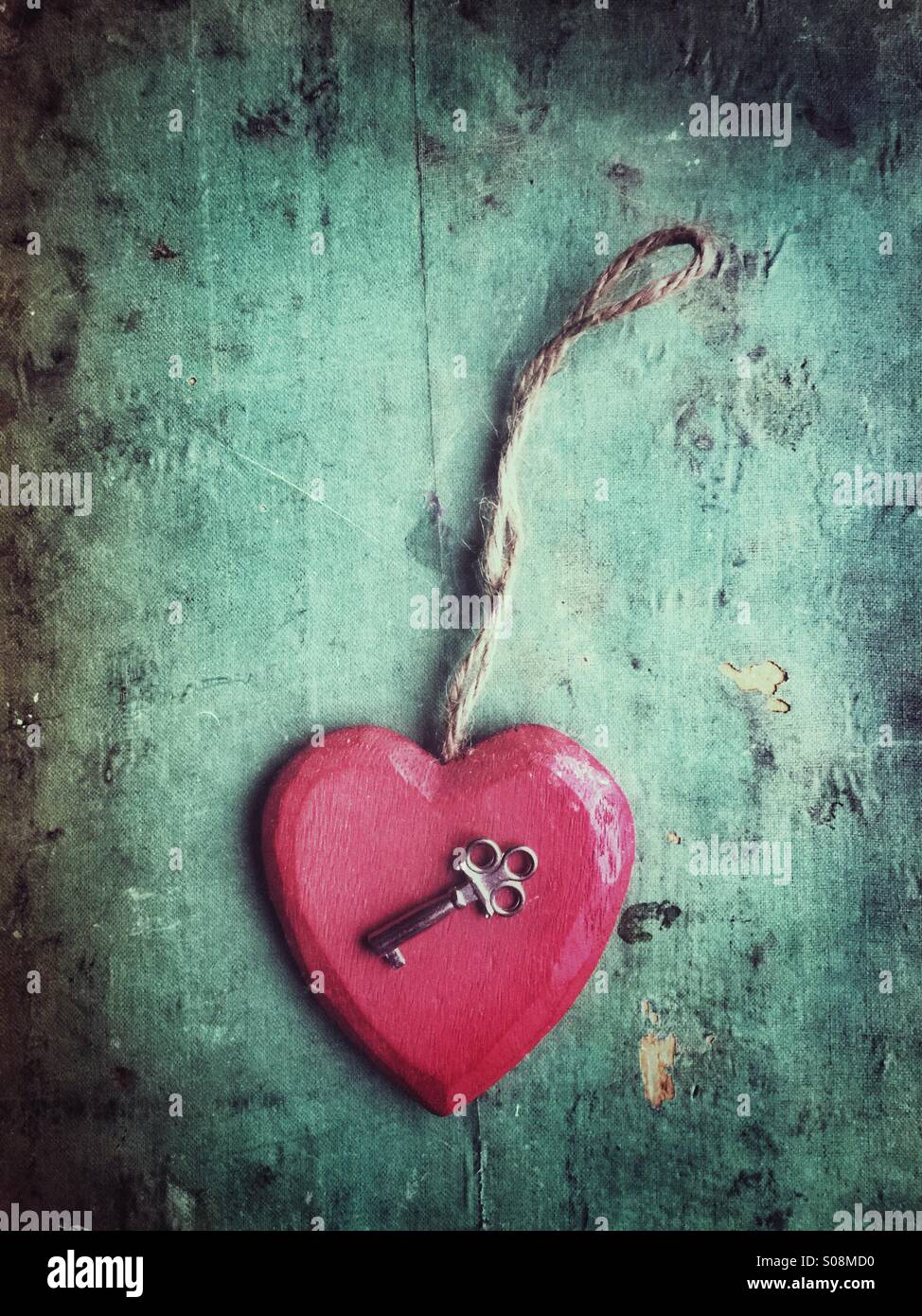 Red wooden heart and a key - Smartphone Captured Stock Image