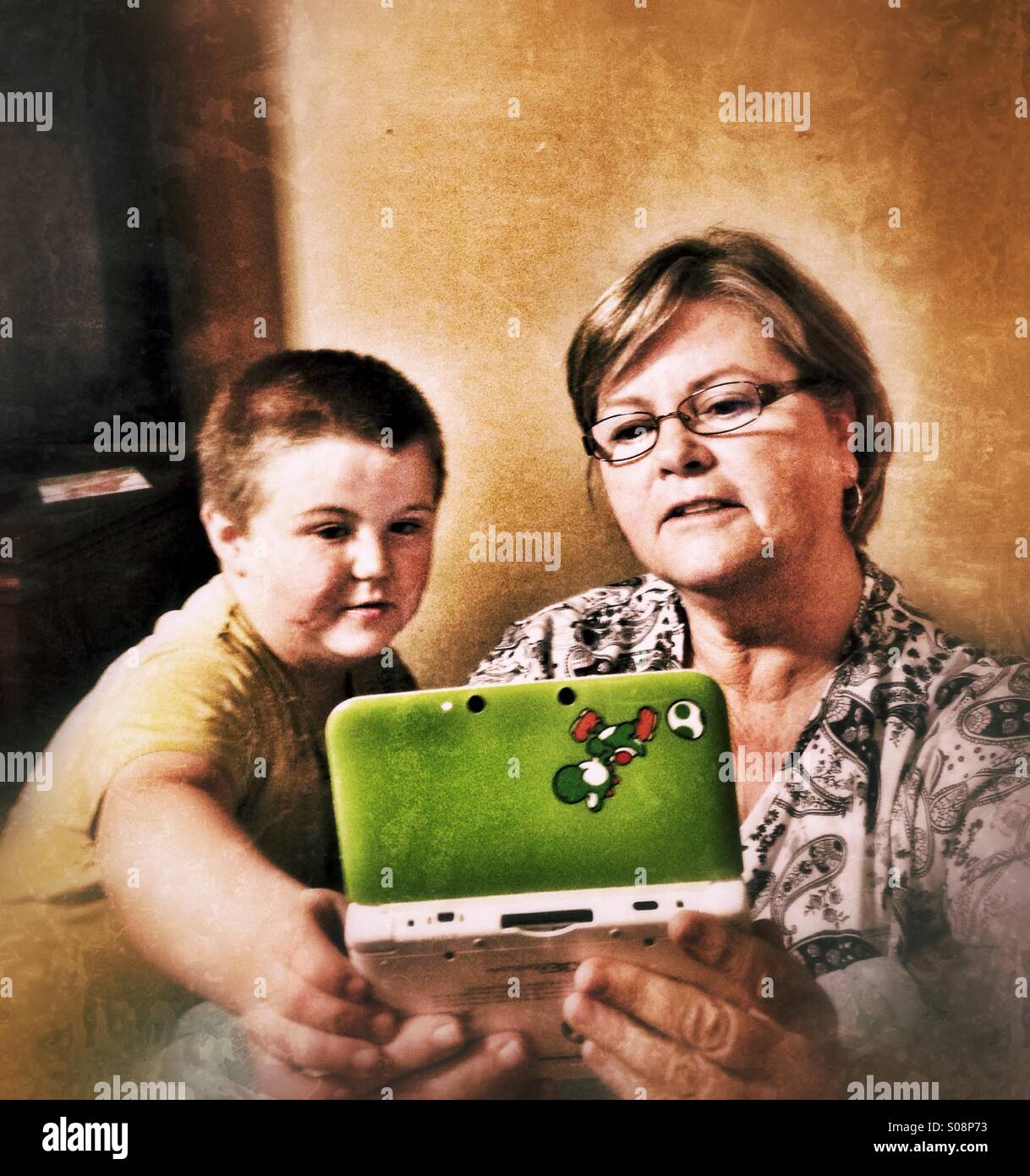 Grandson and grandmother playing a video game. - Smartphone Captured Stock Image