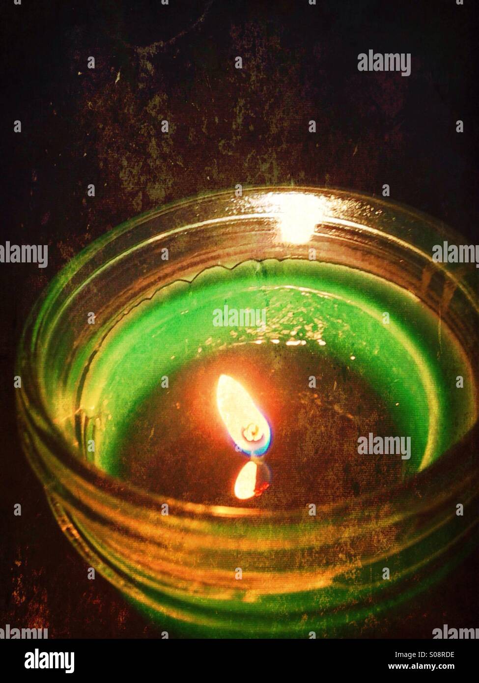 A glowing green candle. - Smartphone Captured Stock Image