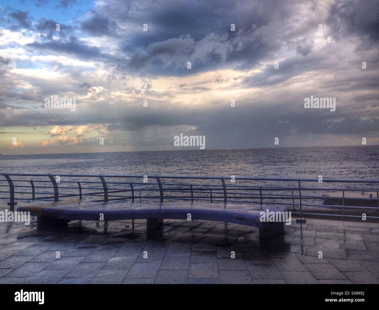 Empty bench in a raining day early morning on the promenade - Beirut Lebanon - Smartphone Captured Stock Image