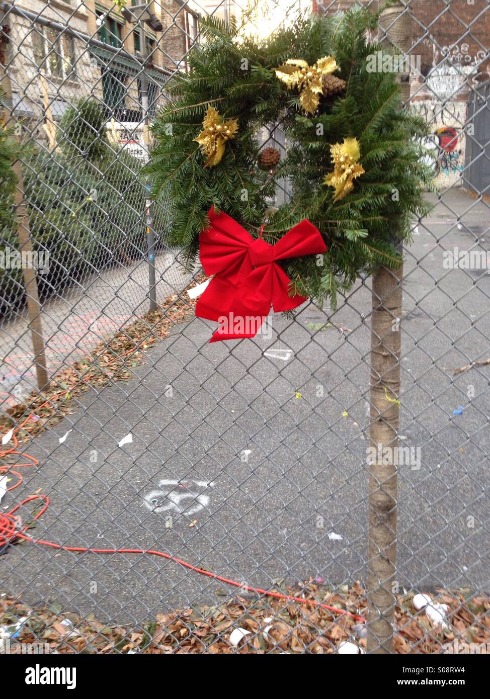 Christmas wreath on sale in empty lot in New York City - Smartphone Captured Stock Image