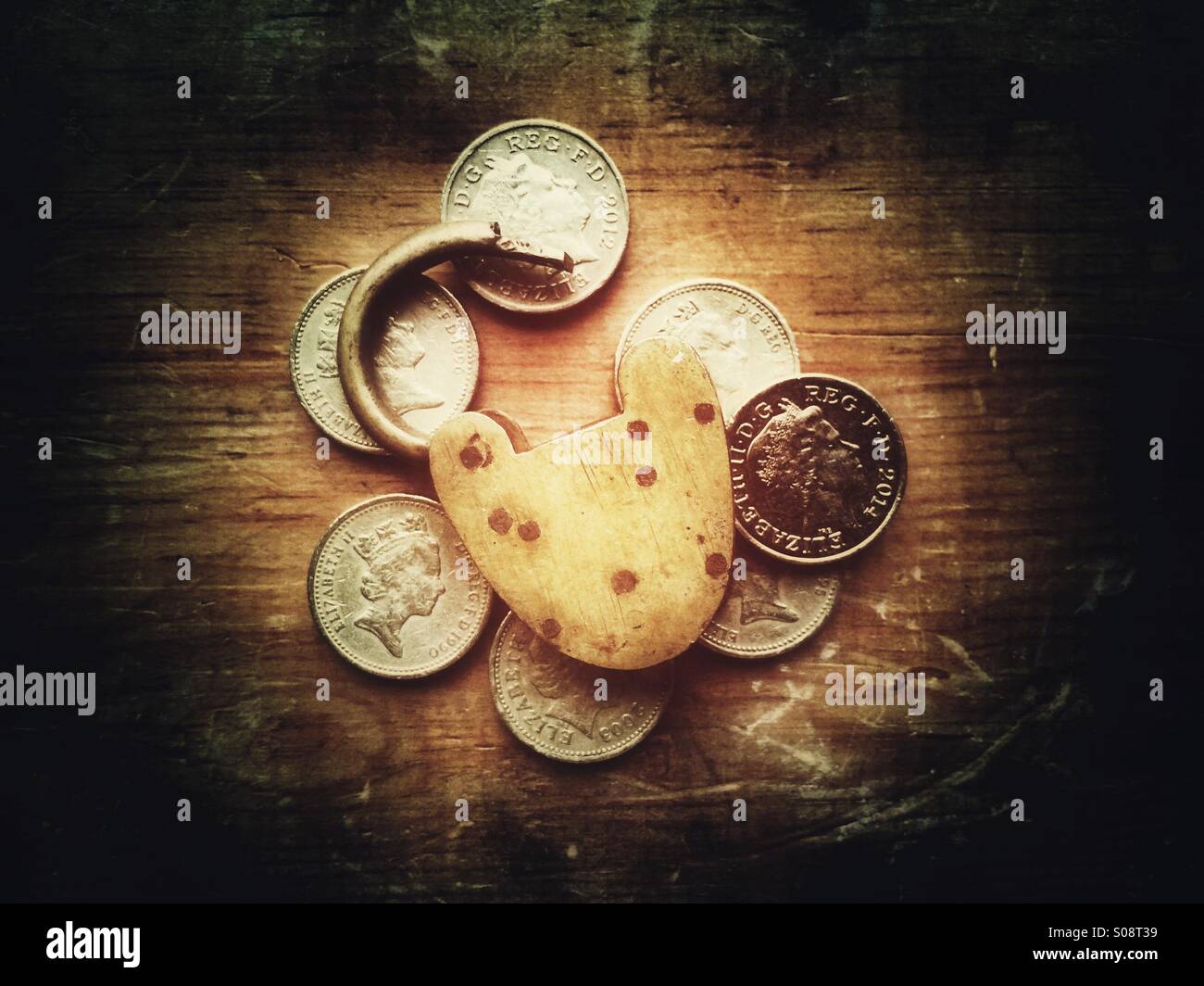 Vintage padlock and British coins - Smartphone Captured Stock Image