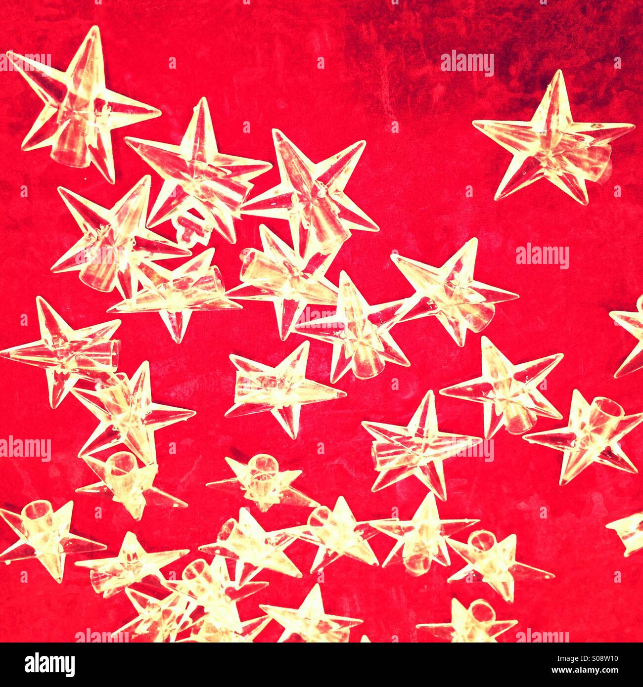 Christmassy stars on red background - Smartphone Captured Stock Image
