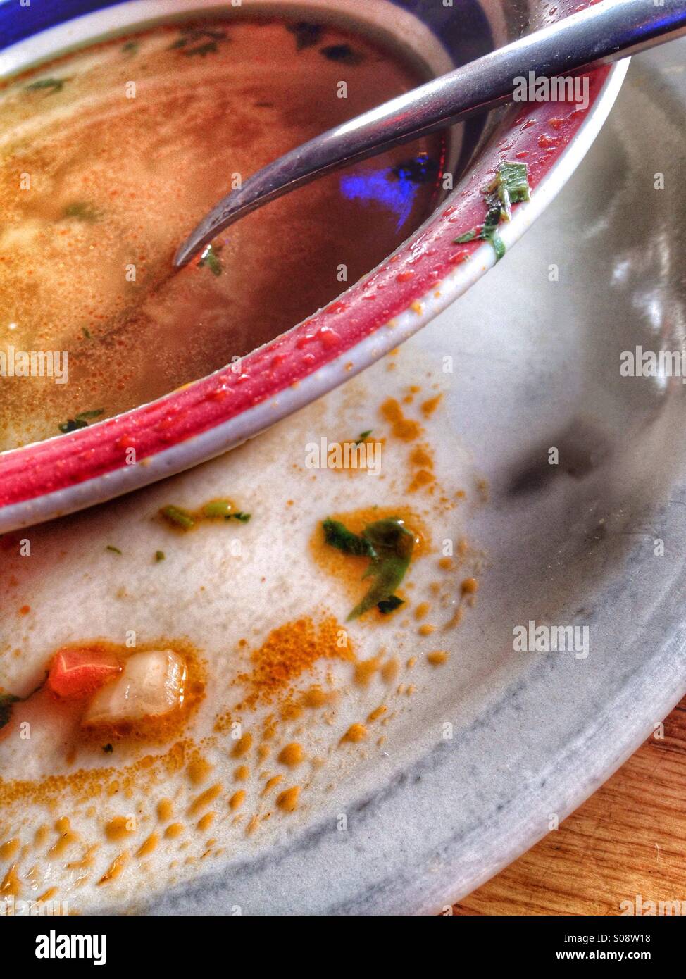 Morsels spilled from soup bowl. - Smartphone Captured Stock Image