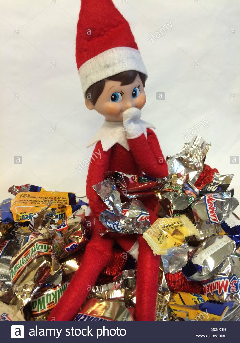 A naughty Christmas elf eats candy in a dish Stock Photo 309982675 Alamy