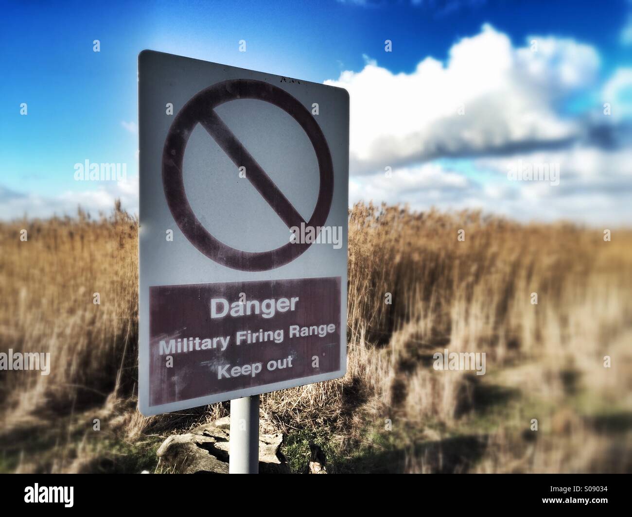 Danger military warning sign in field, firing range - Smartphone Captured Stock Image