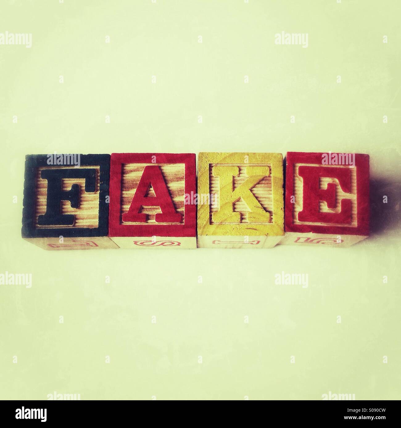 Fake written in wooden alphabet blocks - Smartphone Captured Stock Image