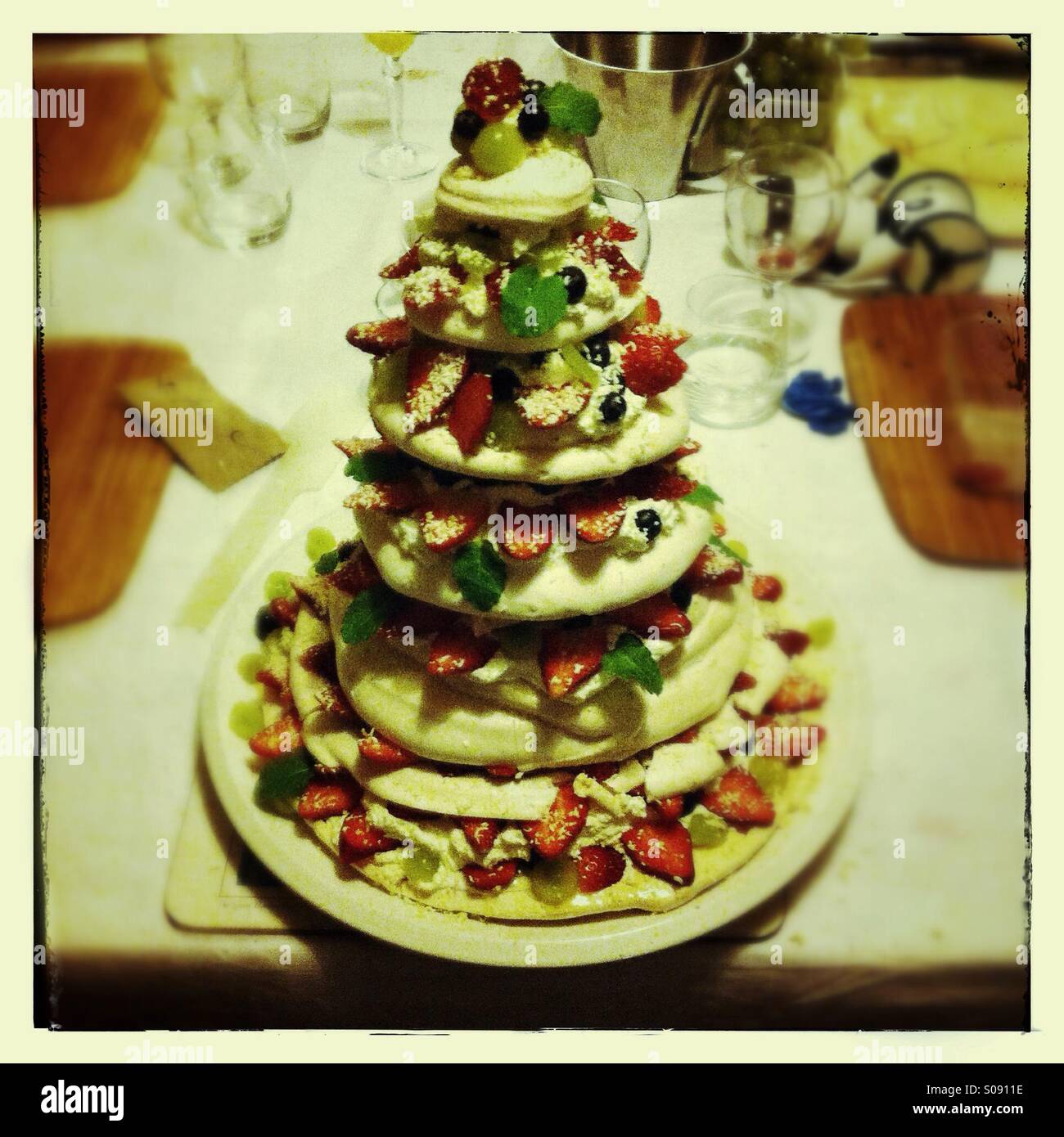 Large stacked pavlova with strawberries grapes and blueberries - Smartphone Captured Stock Image