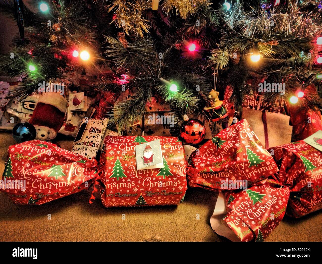 Presents under Christmas tree Stock Photo - Alamy