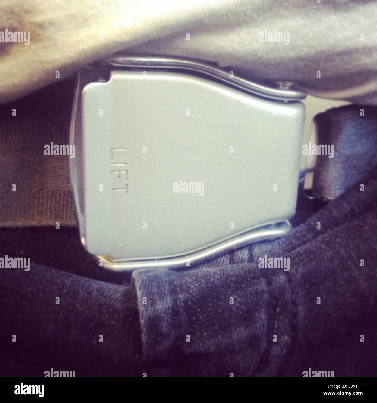 Airplane seatbelt buckle Stock Photo - Alamy