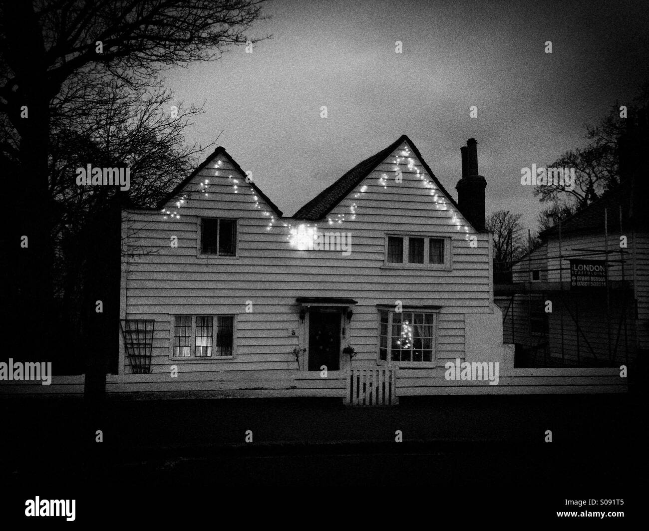 House decorated with Christmas lights,Surrey,UK - Smartphone Captured Stock Image
