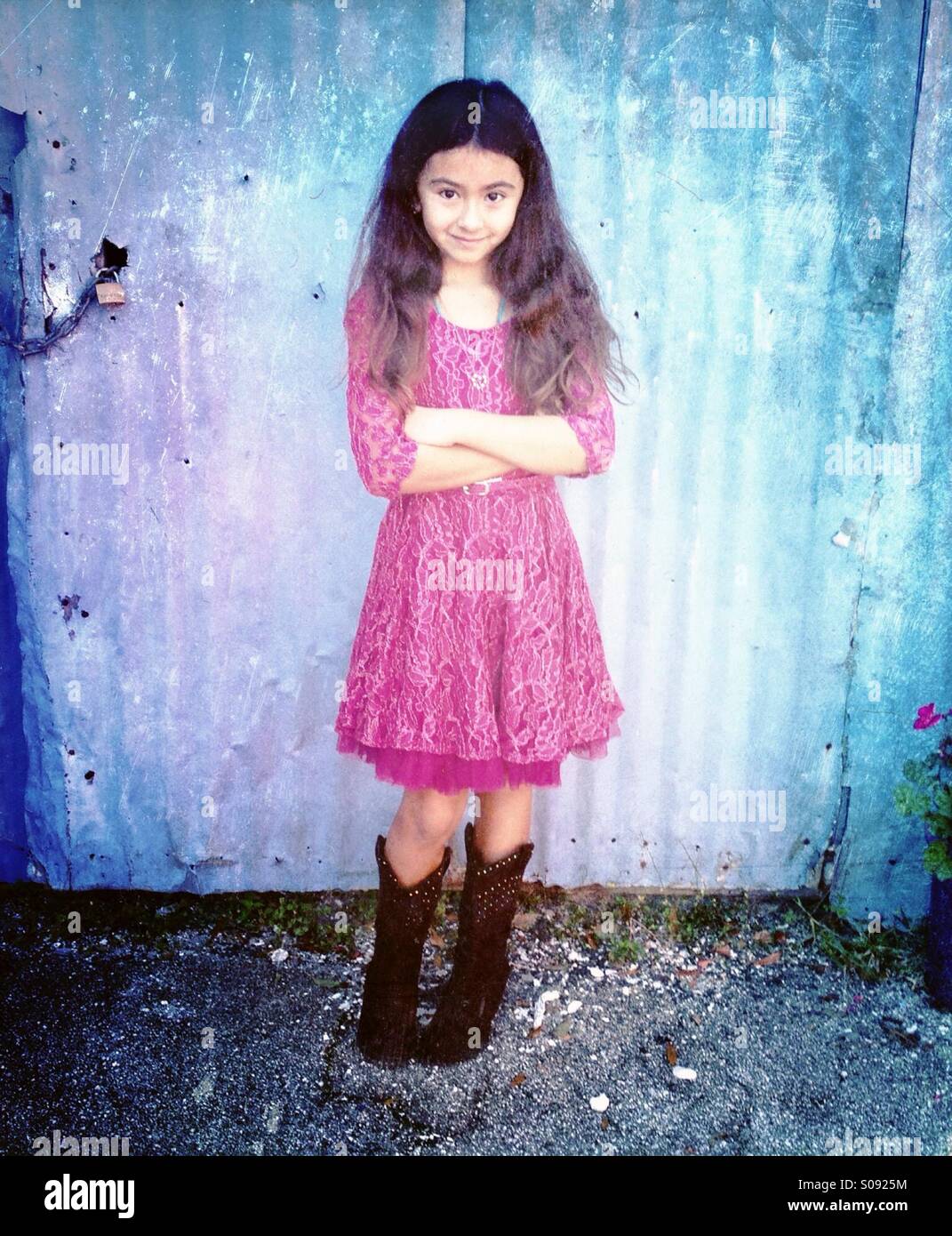 Little girl in pretty dress and cowboy 