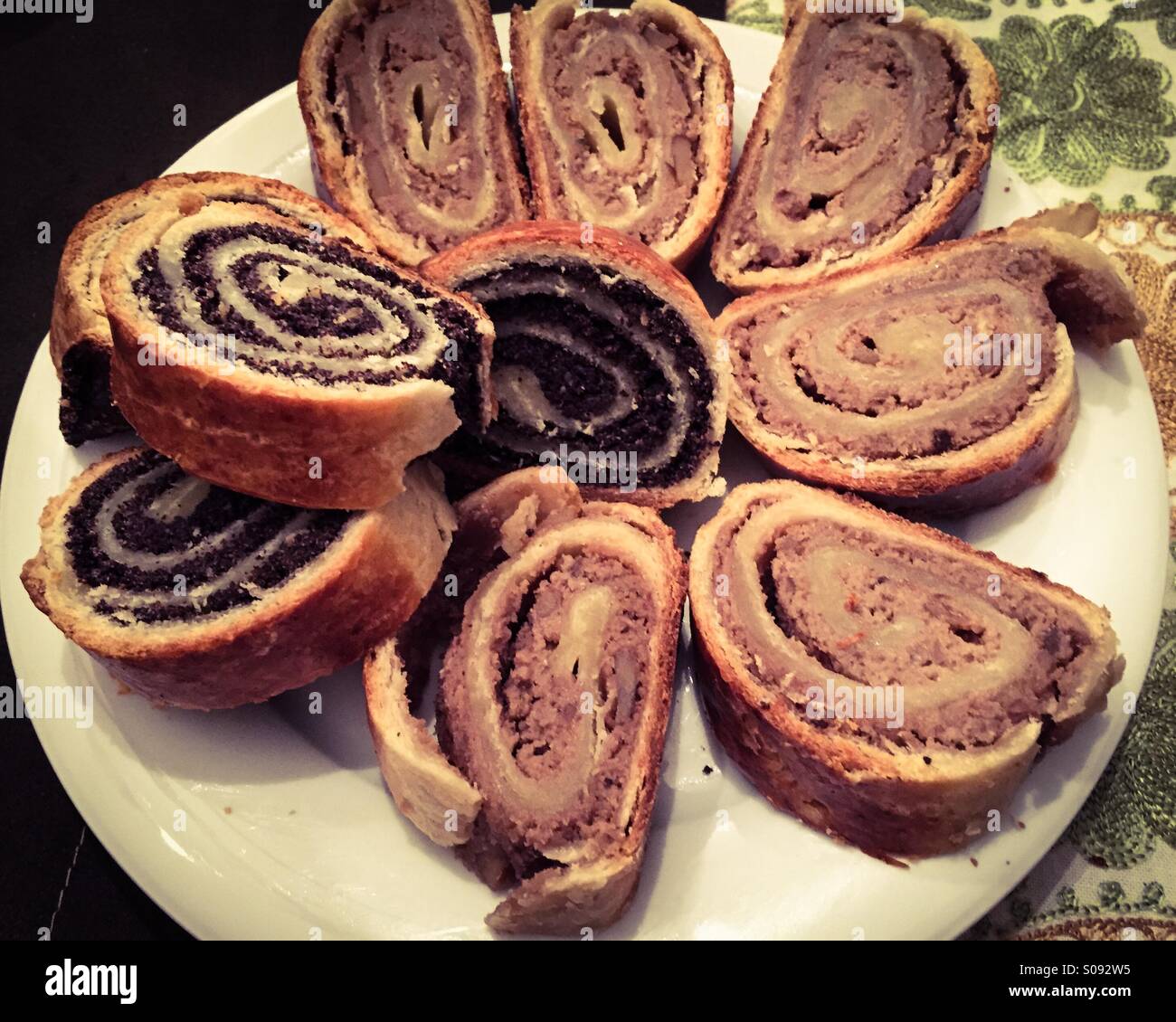 Home baked Hungarian Christmas poppyseed and walnut rolls called 'bejgli' on a plate. - Smartphone Captured Stock Image