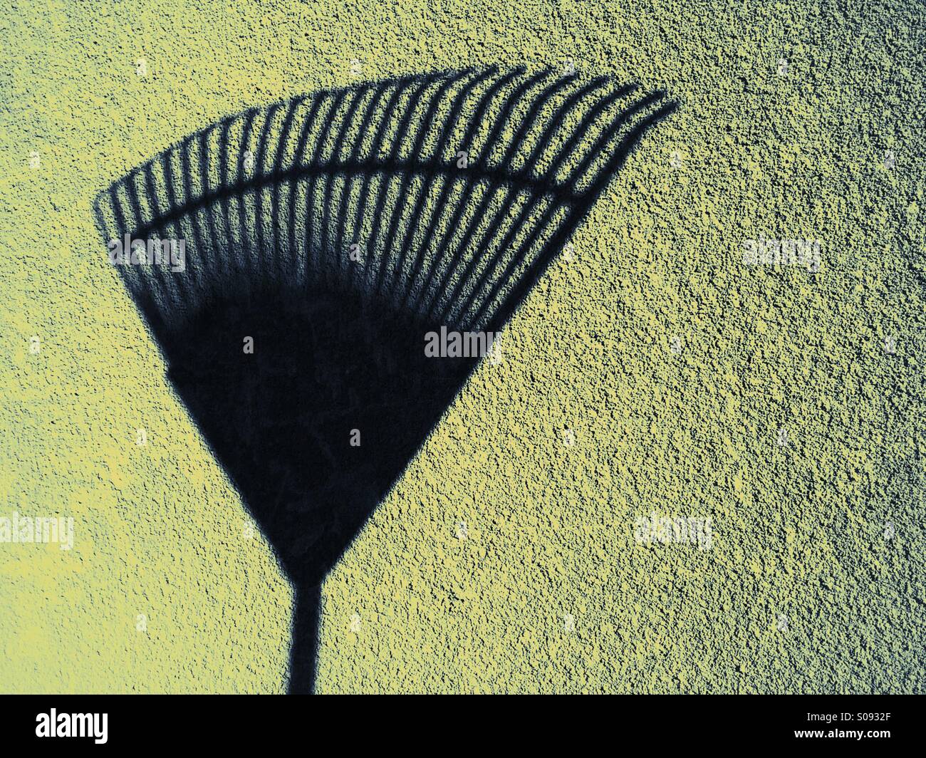 Shadow of a rake against a wall - Smartphone Captured Stock Image