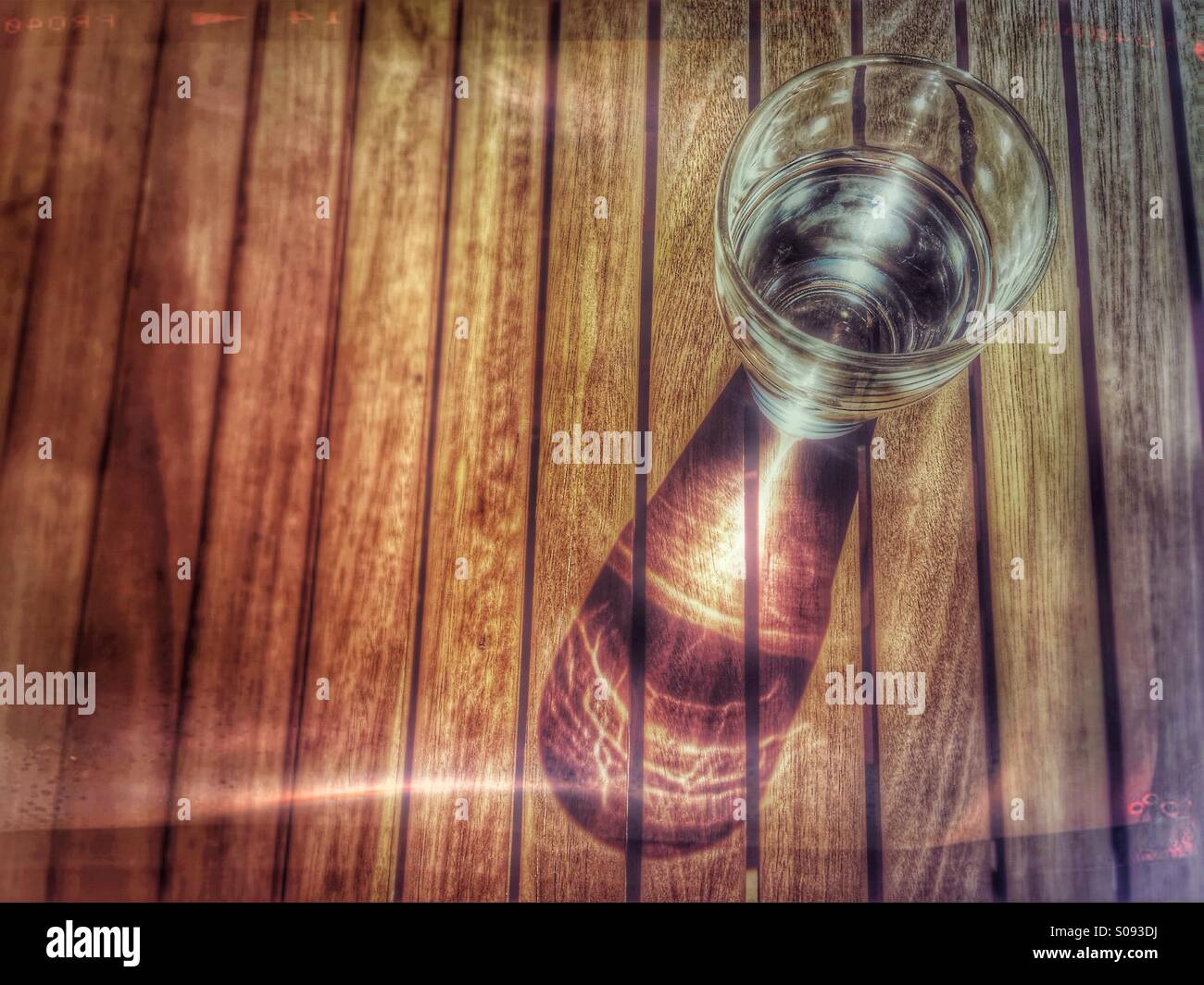 Glass of water on an outdoor wooden table Stock Photo - Alamy