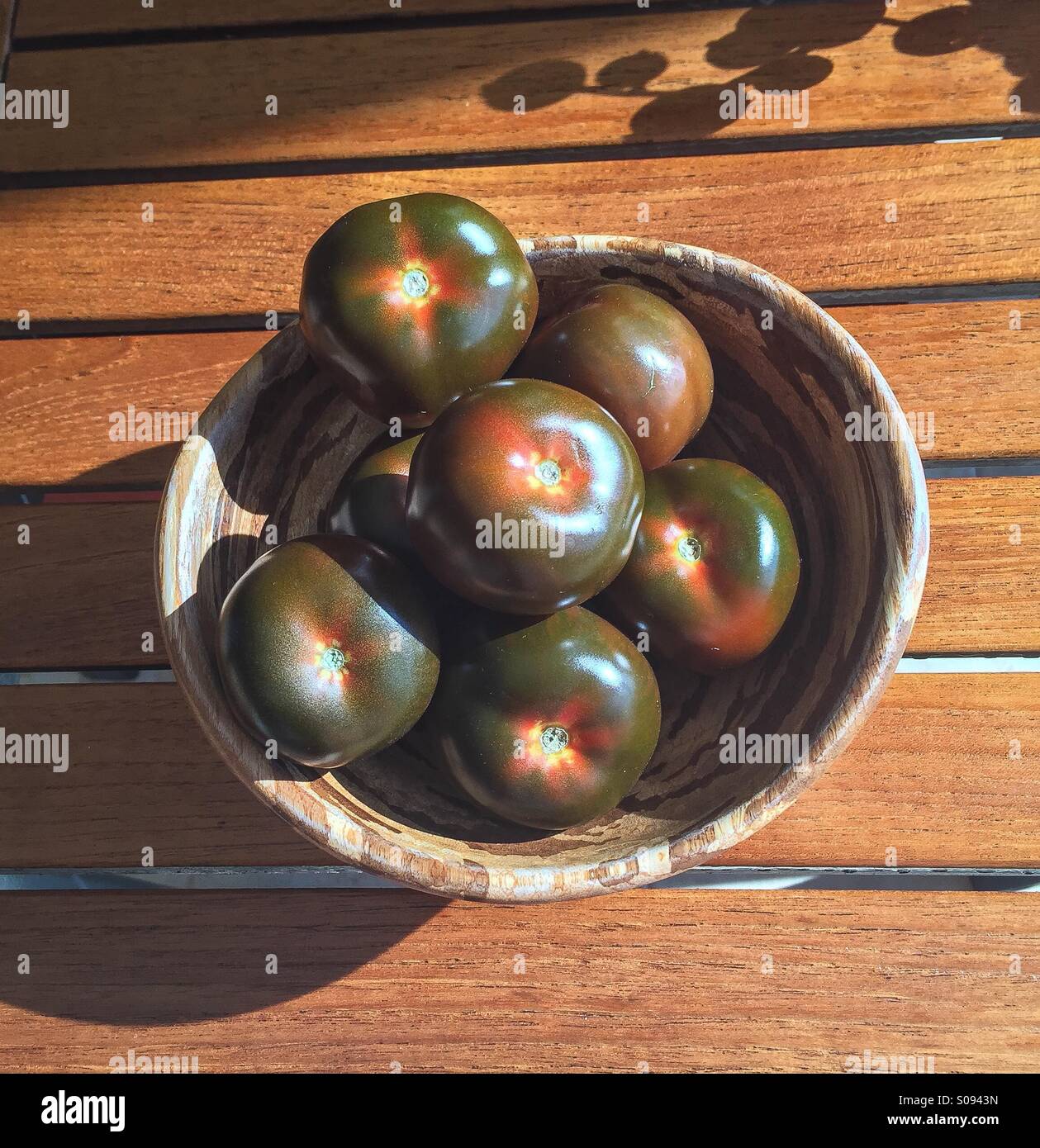 Heirloom Tomatoes in a bowl in sunlight Stock Photo
