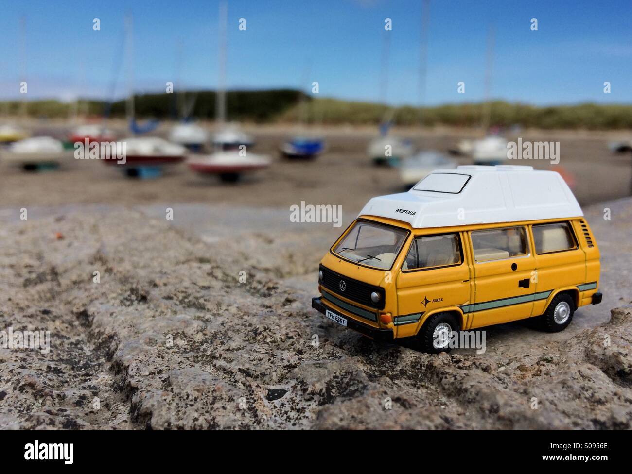 Model VW T25 Transporter Westfalia Joker Camper Van by the sea at Beadnell Bay Northumberland Stock Photo