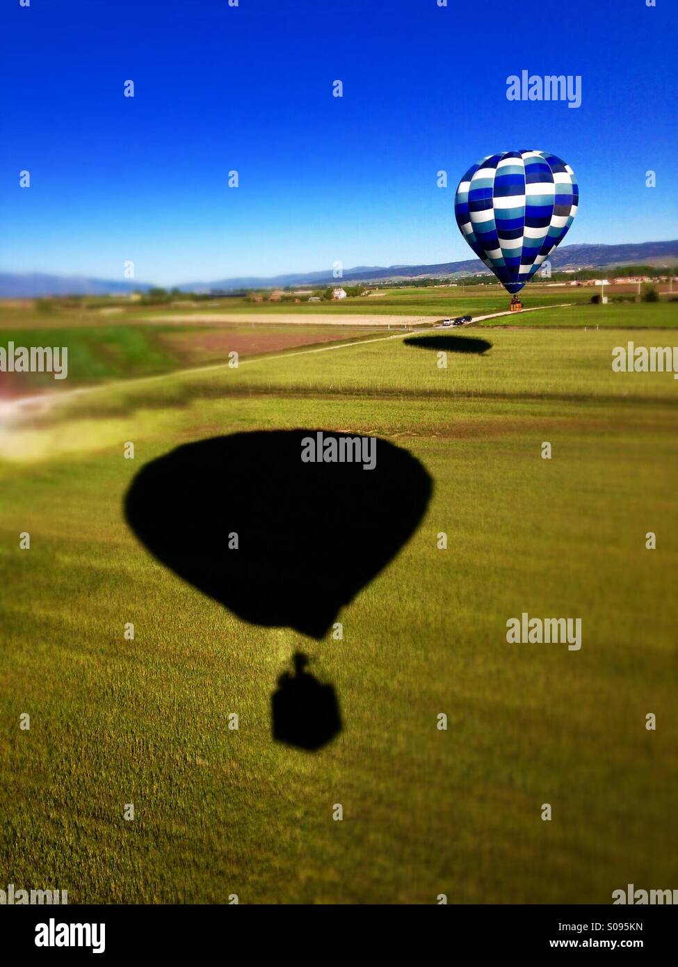 Hot air balloon landing and shade the globe from where the picture was taken. Stock Photo
