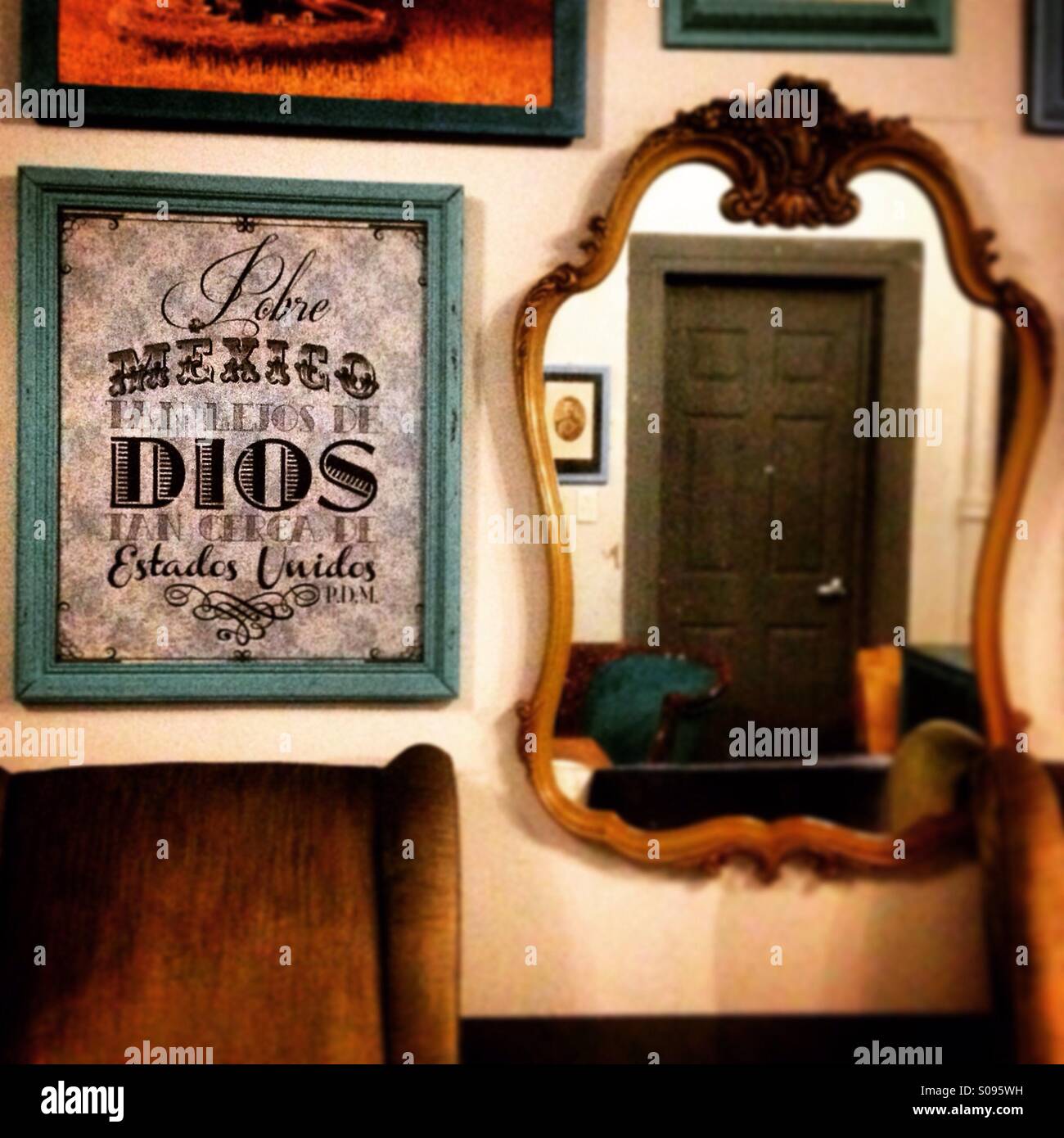 A sign reads 'Poor Mexico, so far away from God, so close to the United States', decorates Don Porfirio coffee shop in Mexico City, Mexico - Smartphone Captured Stock Image