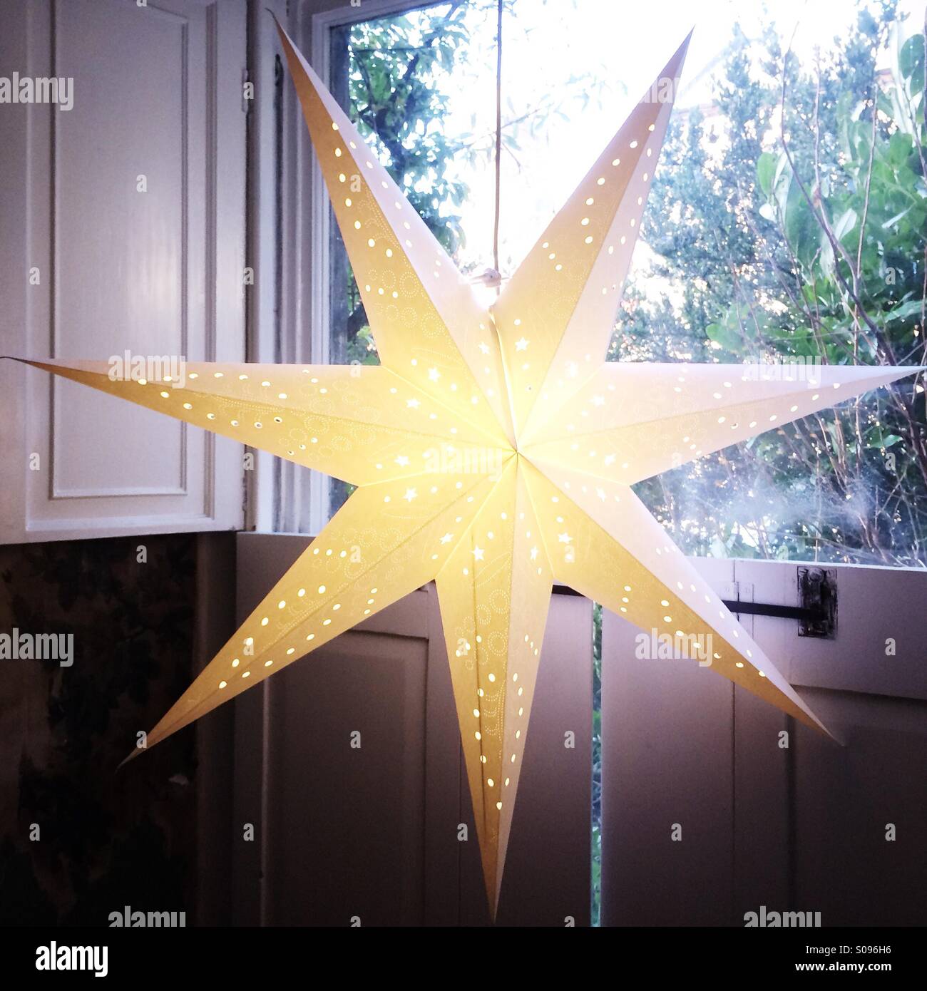 Swedish star lantern in the window at Christmas. - Smartphone Captured Stock Image