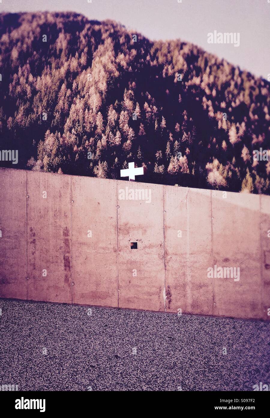 Crucifix behind a modern concrete wall - Smartphone Captured Stock Image