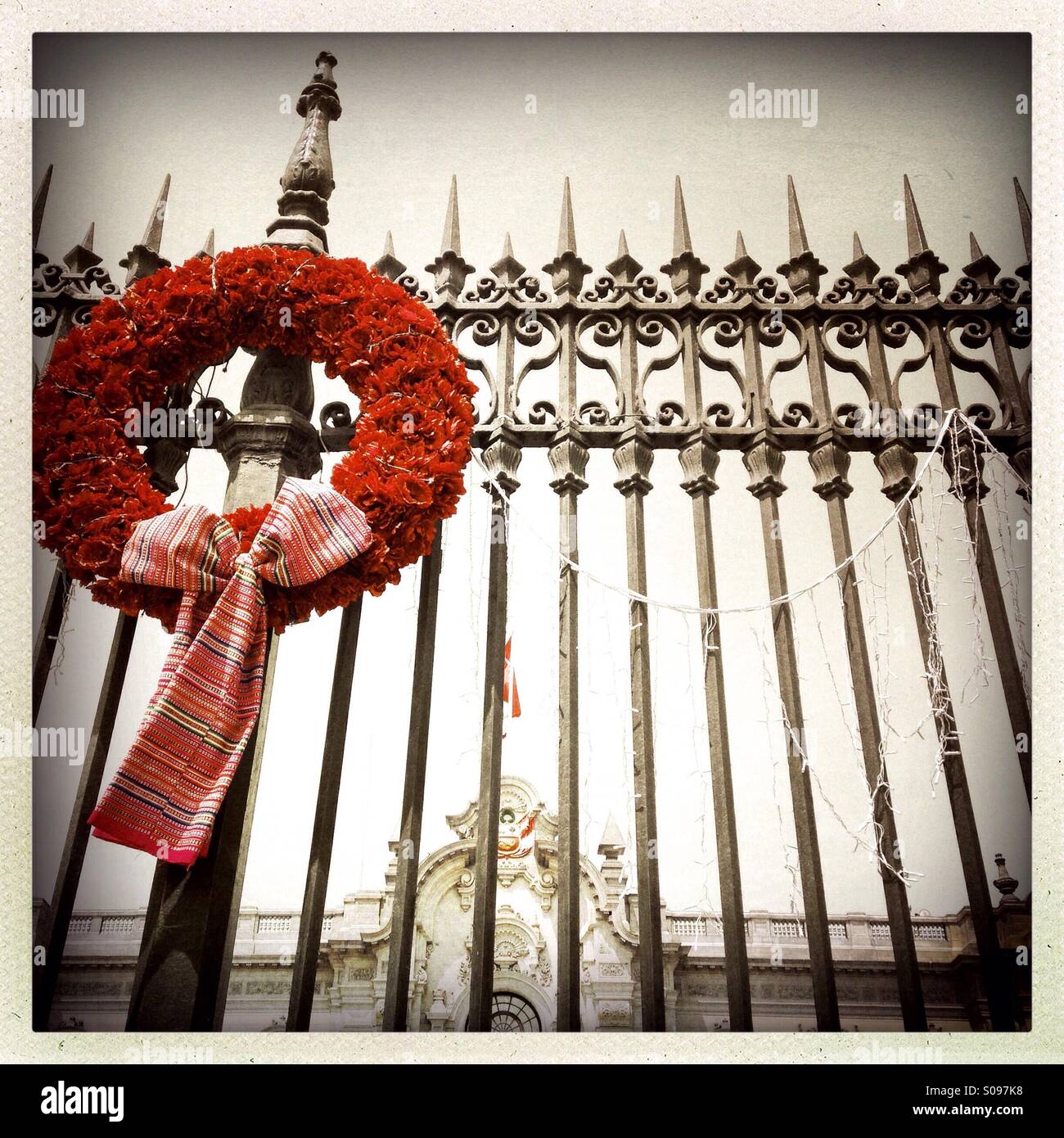 Christmas wreath hanging on wrought iron fence in Plaza de Armas. Lima Peru - Smartphone Captured Stock Image
