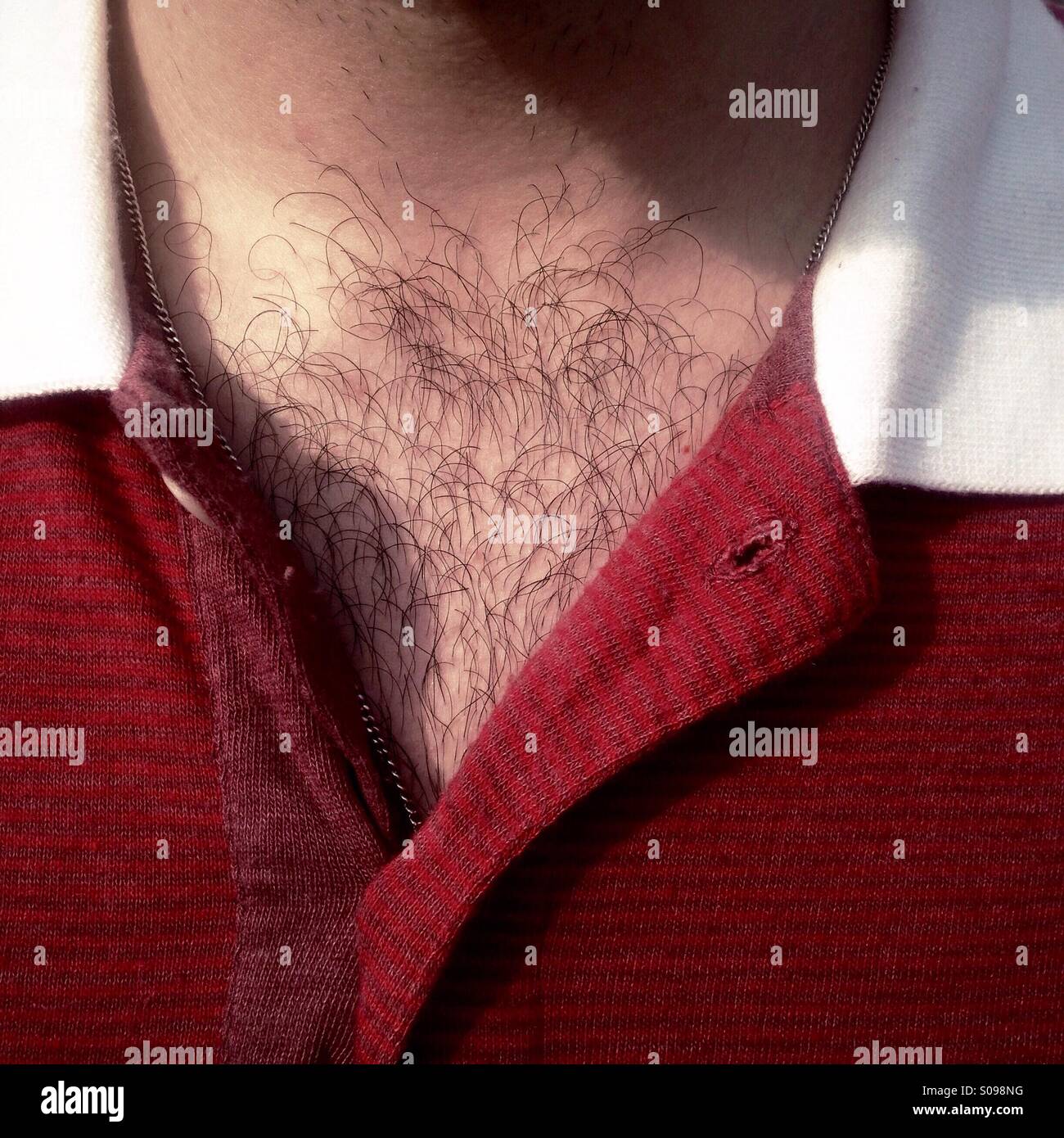 Detail of a hairy chest and red shirt Stock Photo