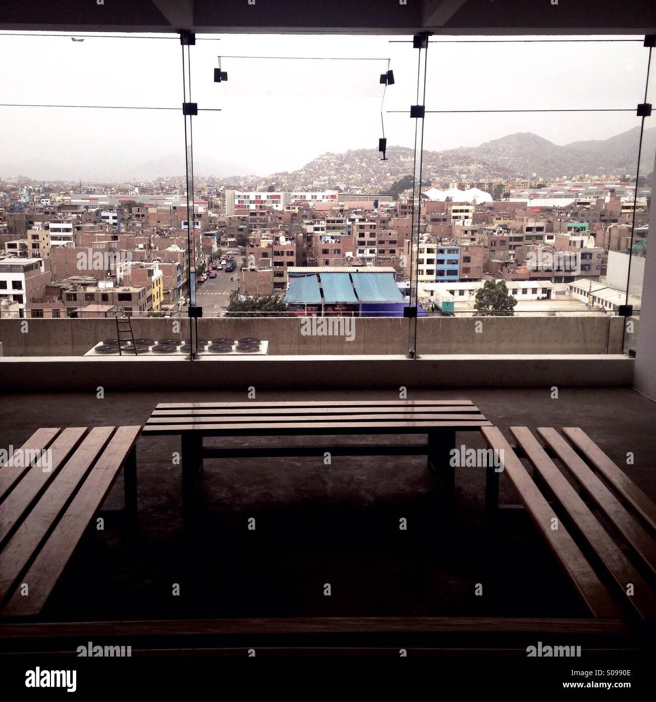 Empty benches look out over sprawling Lima - Smartphone Captured Stock Image