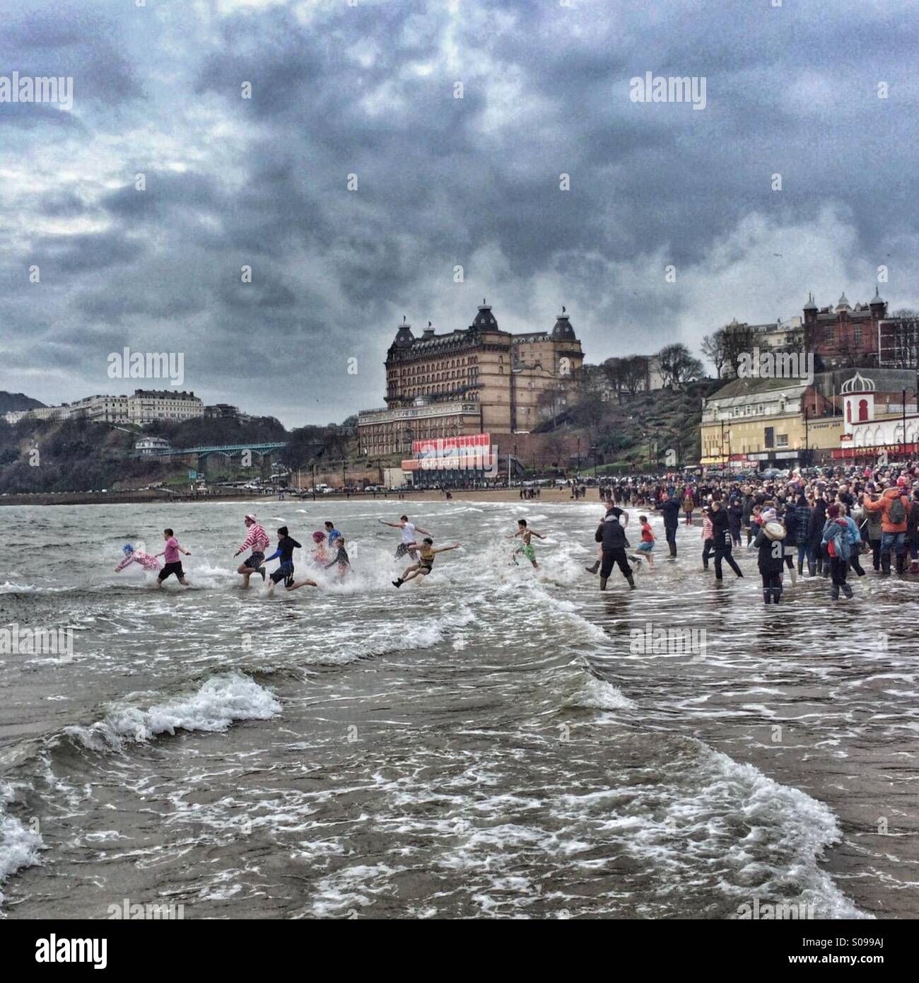 Swimmers brave North Sea for New Year's Day charity swim. - Smartphone Captured Stock Image