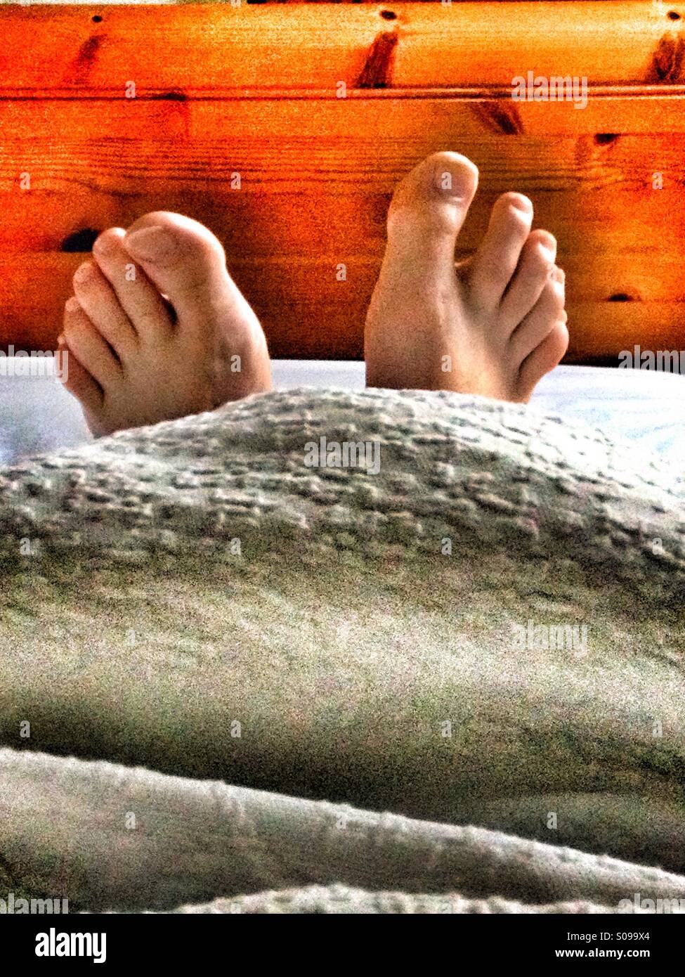 Feet in bed hires stock photography and images Alamy