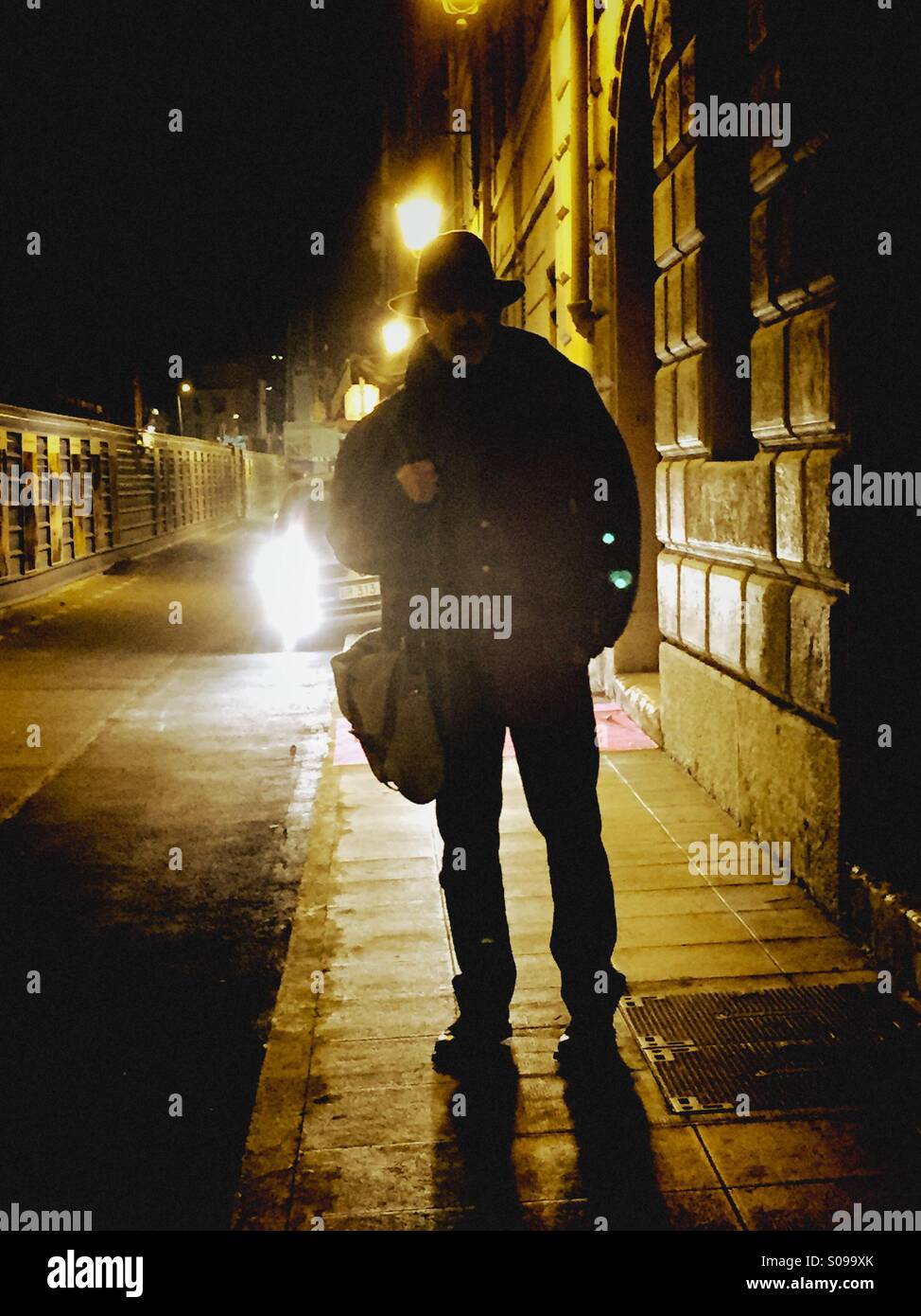 Man on a dark street at night - Smartphone Captured Stock Image