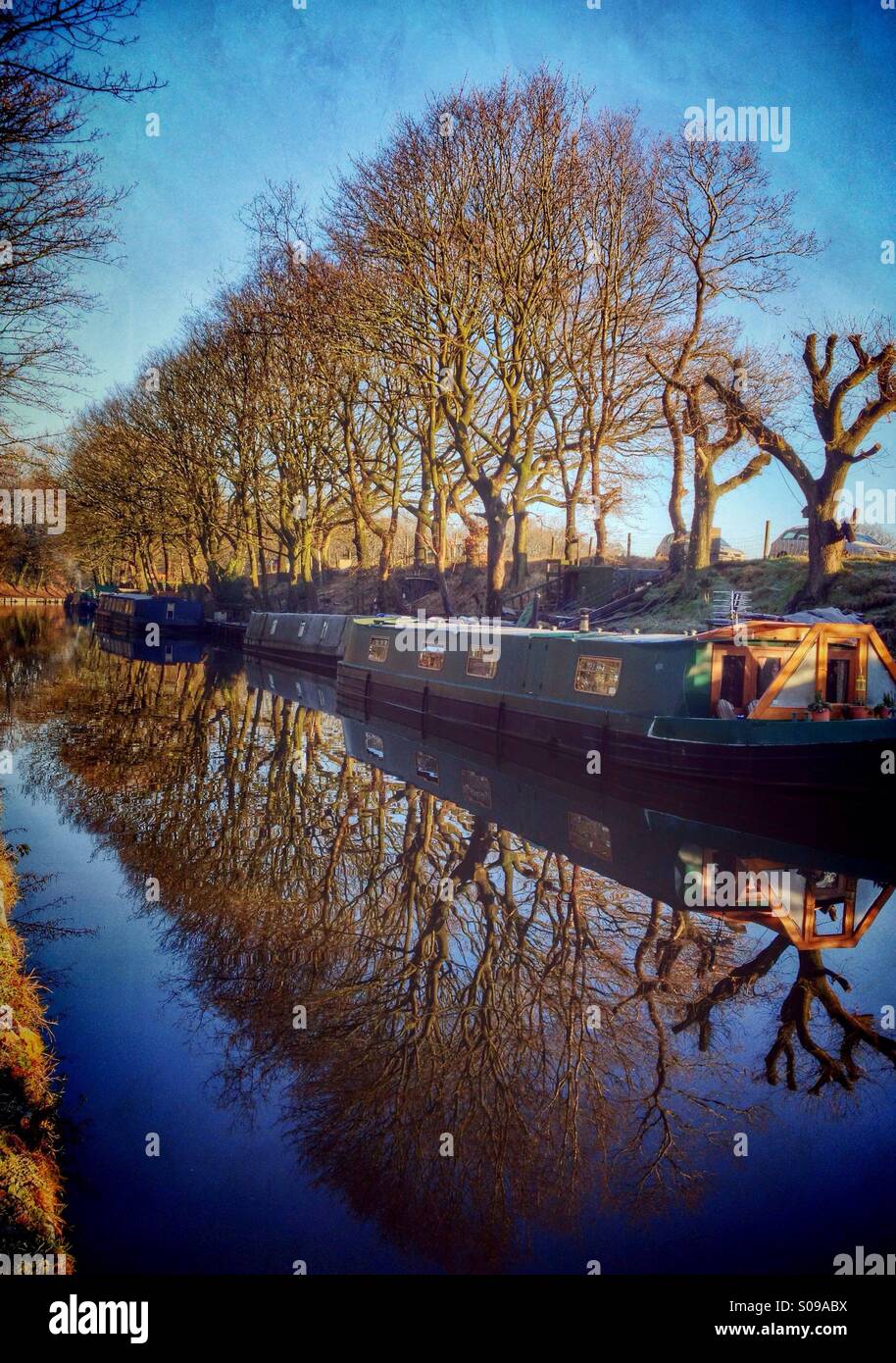 Moored narrow boats on Leeds and Liverpool canal near Chorley in early morning light - Smartphone Captured Stock Image
