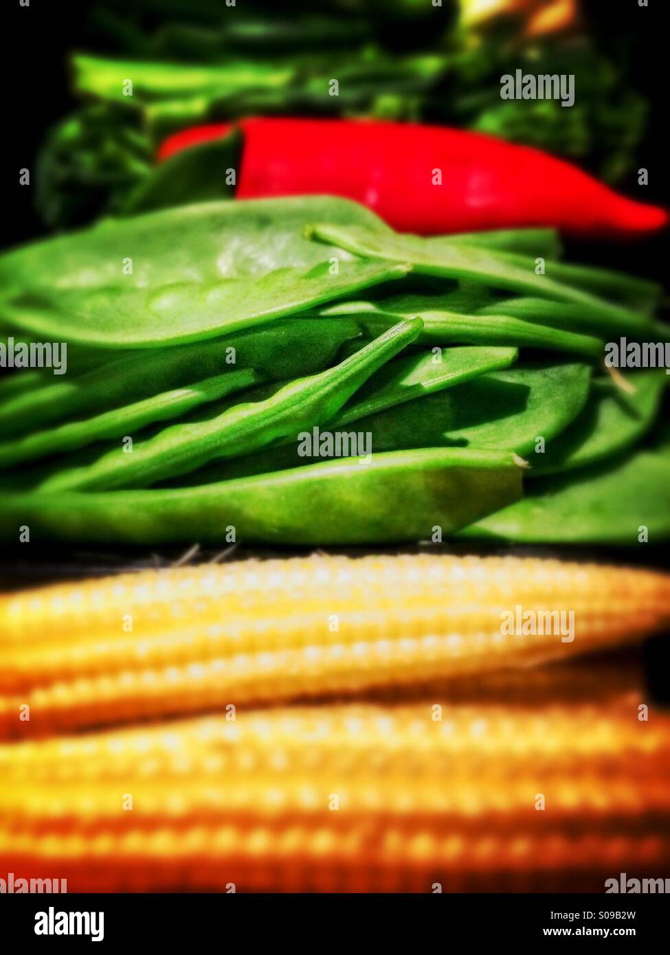 Fresh mixed vegetables baby corns snow peas red chilli Stock Photo