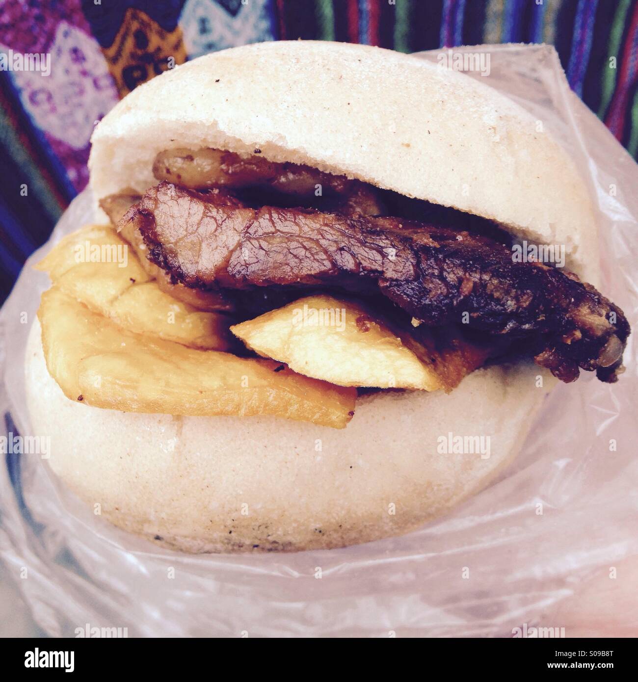 Peruvian breakfast sandwich of pan, chicharron and camote or bread, fried pork and sweet potato - Smartphone Captured Stock Image